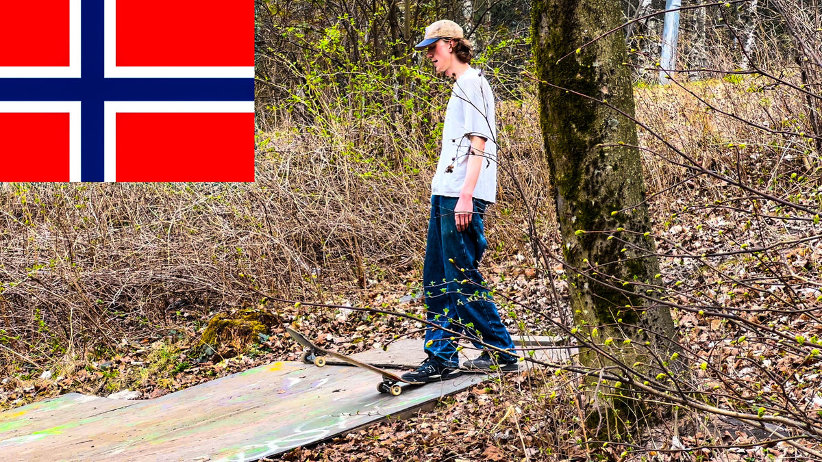 Skateboarding in Norway: a skater rolls across a plywood DIY setup in the woods, from Mike Boisvert's Norway video cover. Photo by Mike Boisvert / The Skate Nomad