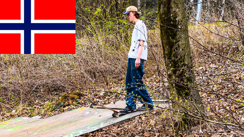 Skateboarding in Norway: a skater rolls across a plywood DIY setup in the woods, from Mike Boisvert's Norway video cover. Photo by Mike Boisvert / The Skate Nomad