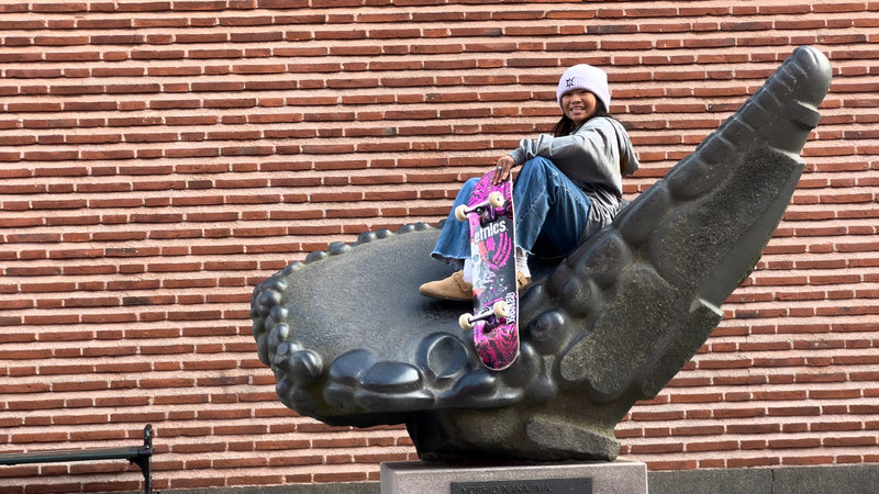 Skateboarding in Malmö, Sweden: Mazel Paris sits on a sculpture in front of a brick wall, board in hand. Photo by Mike Boisvert / The Skate Nomad
