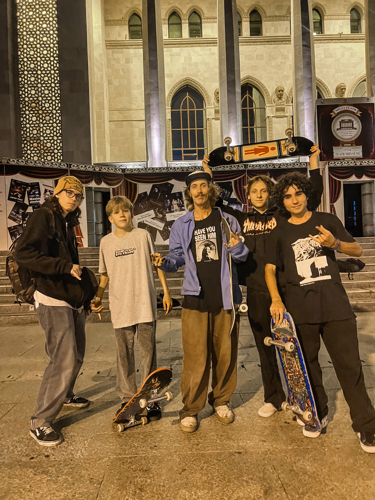 Skateboarding in Baku, Azerbaijan: Mike Boisvert with four young local skaters on the steps of a theater at night. Photo by Mike Boisvert / The Skate Nomad