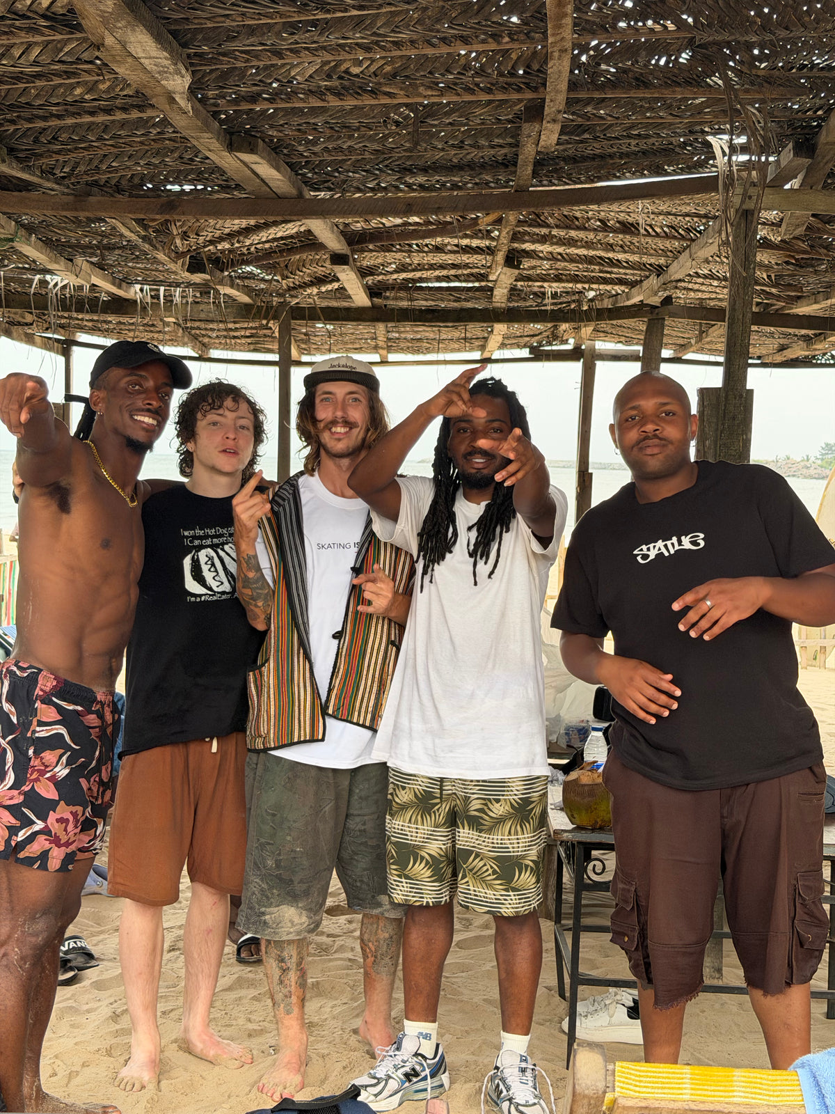 Nigeria: Mike Boisvert with the crew under a beach shelter. Photo by Mike Boisvert / The Skate Nomad