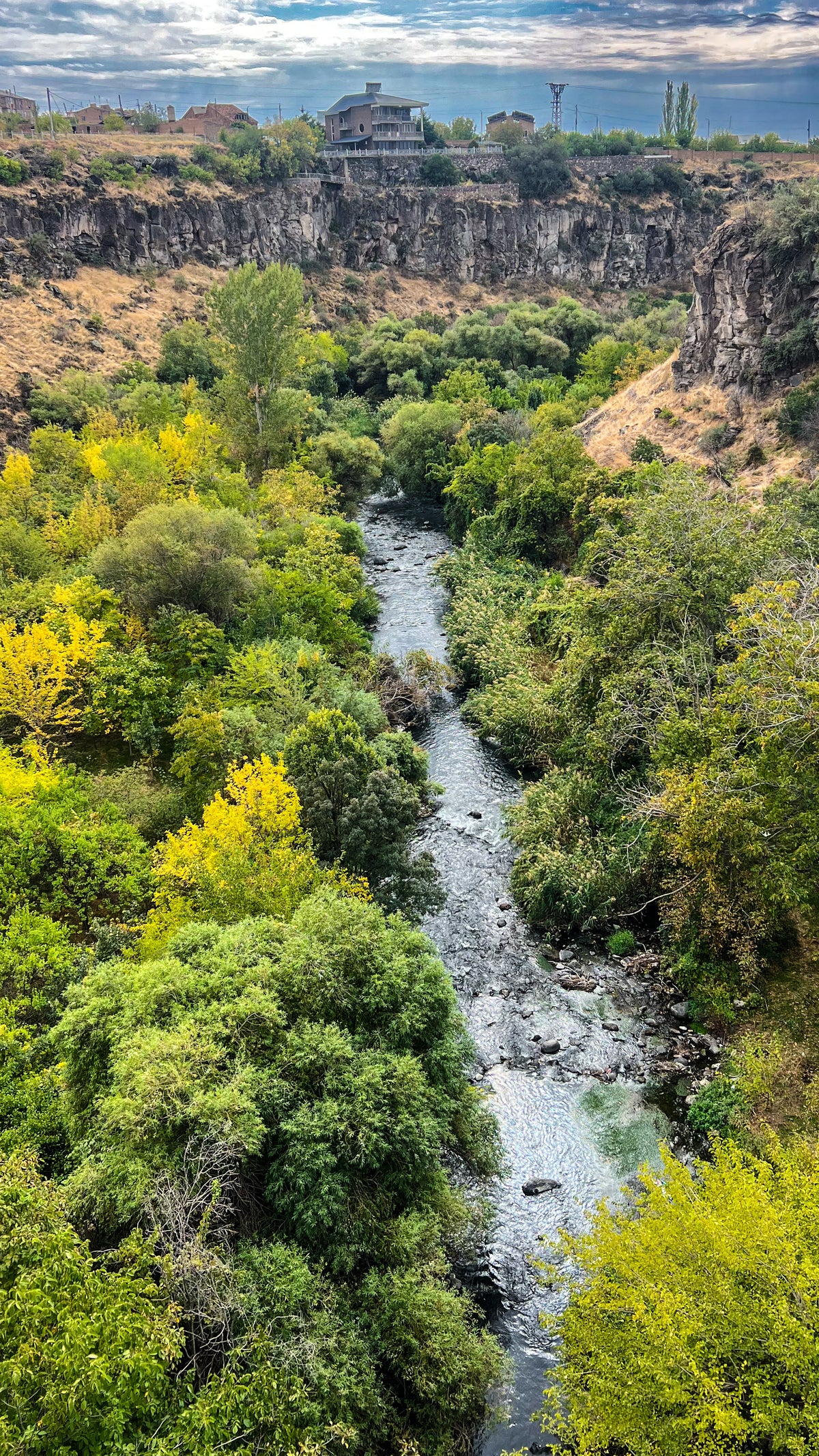 Armenia: a river winds through a deep green gorge lined with trees and rocky cliffs. Photo by Mike Boisvert / The Skate Nomad