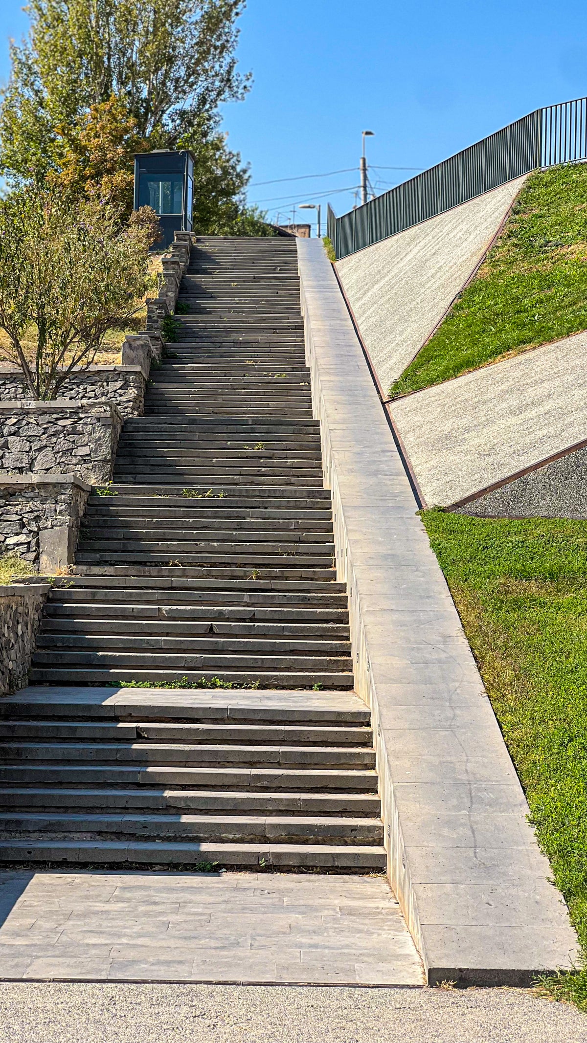 Skateboarding in Armenia: a long granite stair set with a smooth ledge beside it. Photo by Mike Boisvert / The Skate Nomad