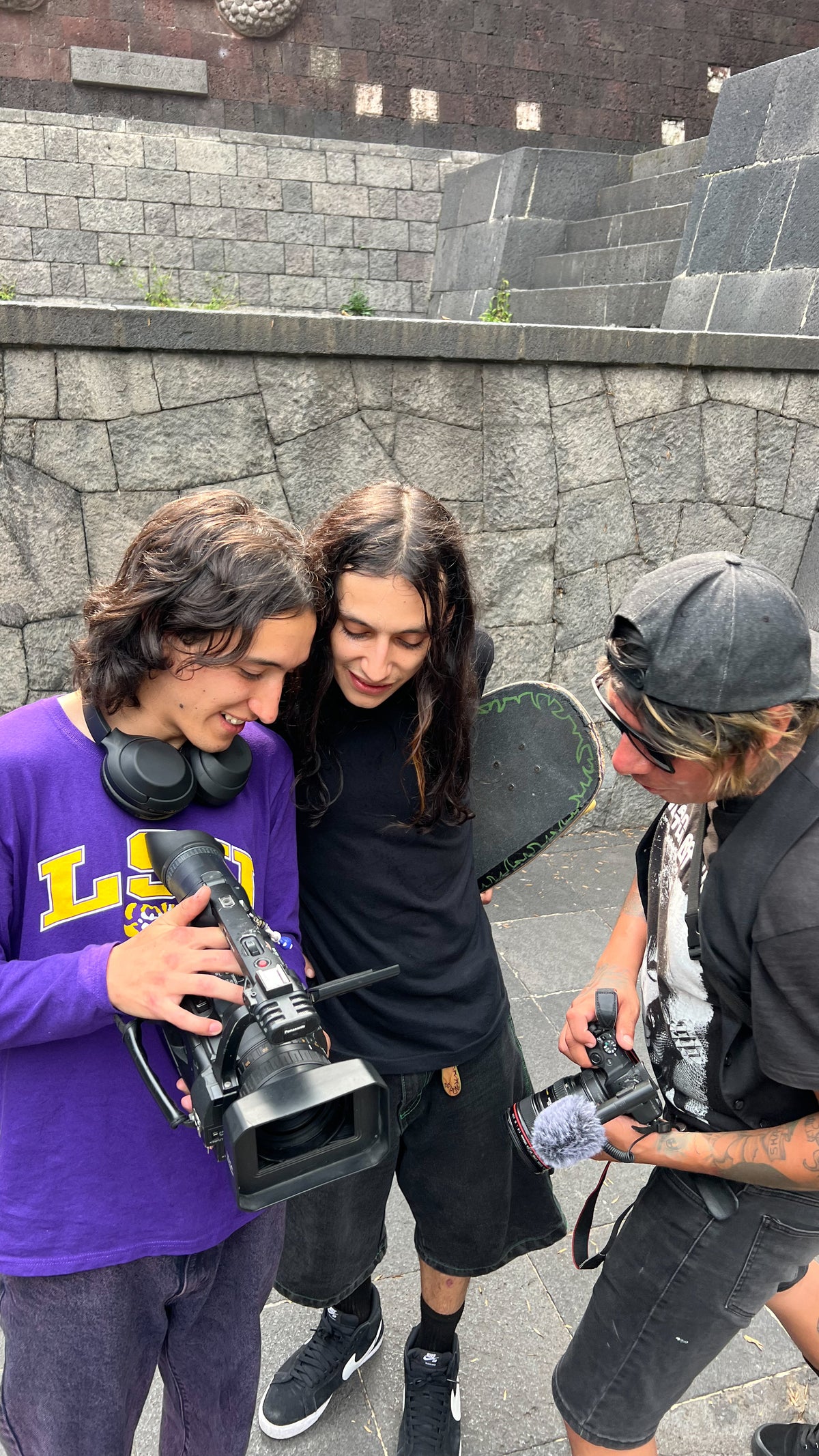 Skateboarding in Mexico City: three skaters check the footage on a camera. Photo by Mike Boisvert / The Skate Nomad
