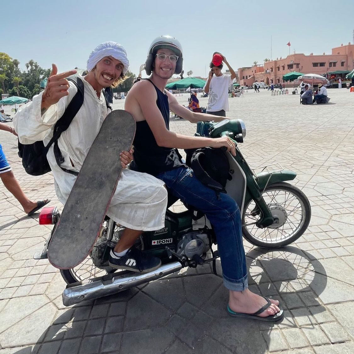 Marrakesh, Morocco: Mike Boisvert, still in the outfit, rides on the back of a scooter with his board. Photo by Mike Boisvert / The Skate Nomad
