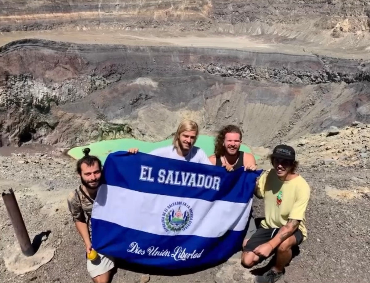 El Salvador: Mike Boisvert and friends hold the Salvadoran flag on the crater rim of the Santa Ana volcano. Photo by Mike Boisvert / The Skate Nomad
