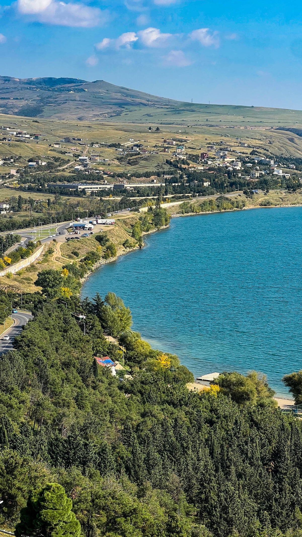 Georgia: a turquoise lake below green wooded hills. Photo by Mike Boisvert / The Skate Nomad
