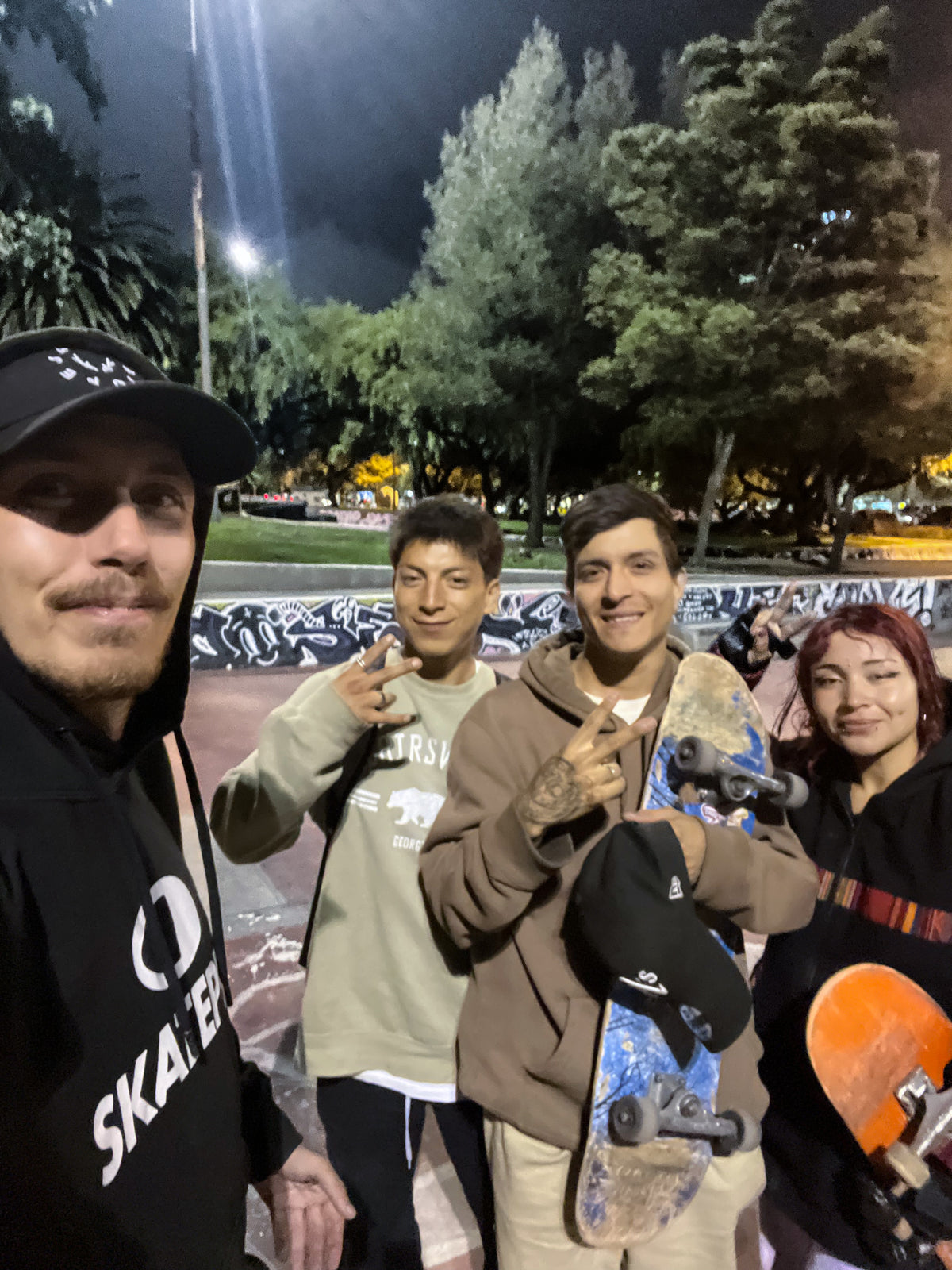 Quito, Ecuador: Mike Boisvert takes a selfie with local skaters at night. Photo by Mike Boisvert / The Skate Nomad