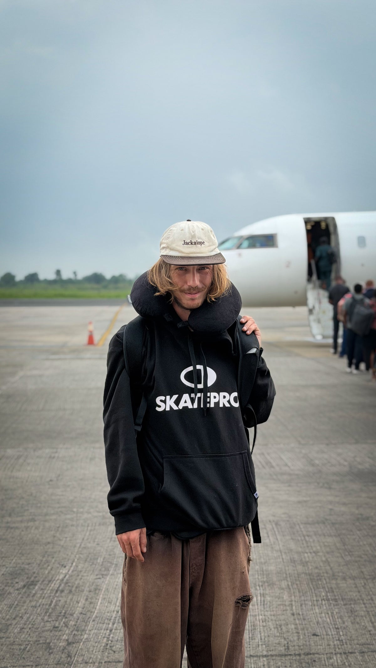Nigeria: Mike Boisvert on the tarmac in front of the plane. Photo by Mike Boisvert / The Skate Nomad