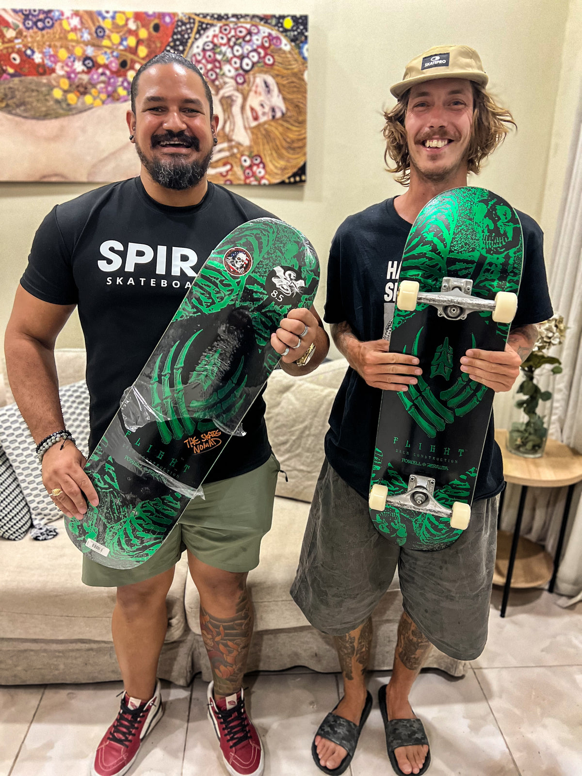 Dominican Republic: Mike Boisvert and a member of Spiral Skateboarding hold matching green decks. Photo by Mike Boisvert / The Skate Nomad
