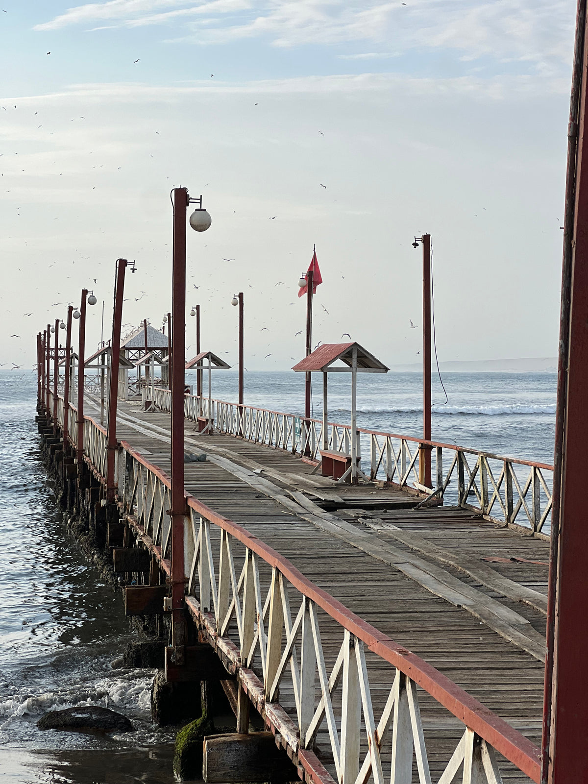 Peru: a long wooden pier over the water at dawn. Photo by Mike Boisvert / The Skate Nomad
