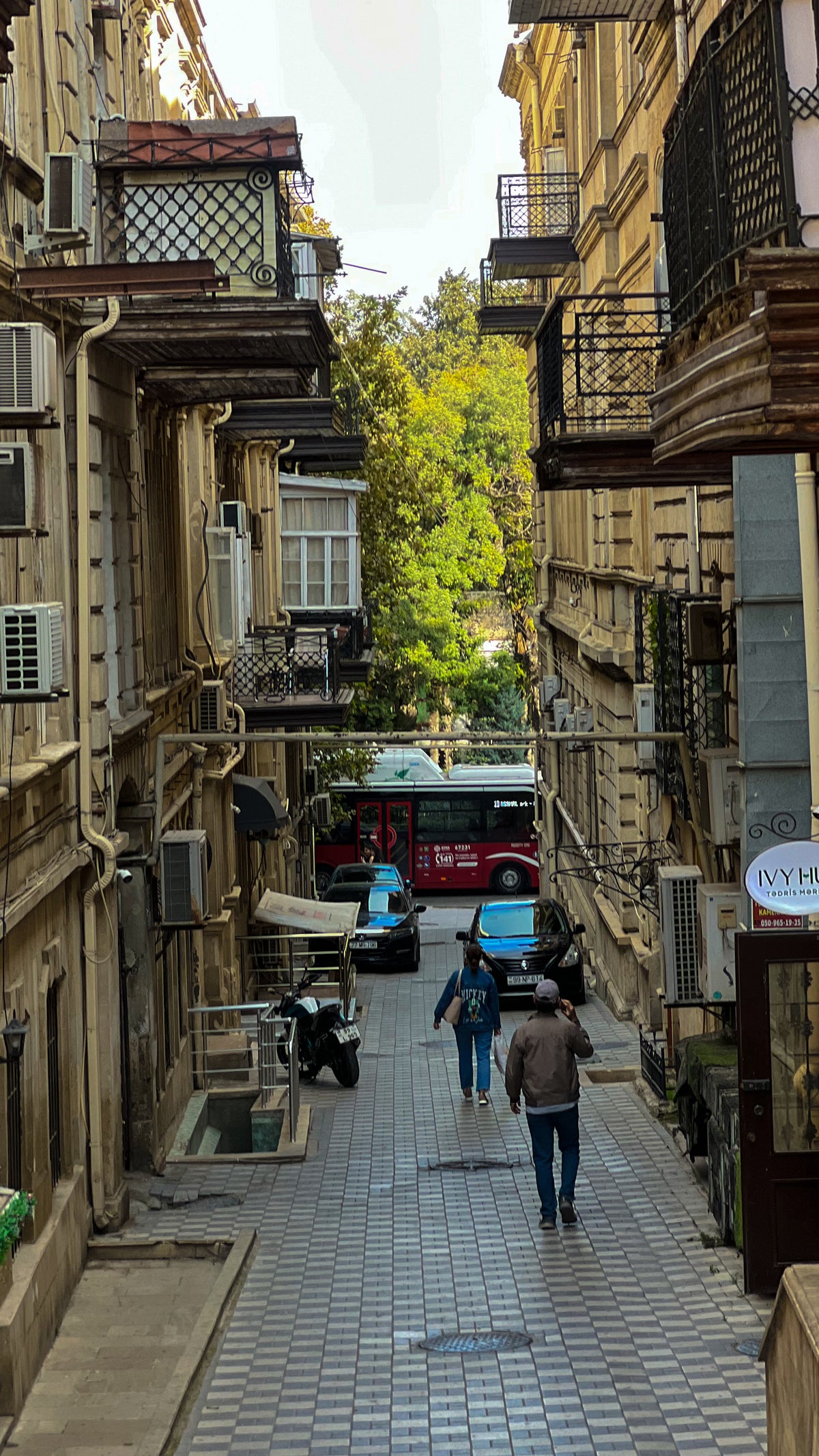 Downtown Baku, Azerbaijan: a narrow paved street between old balconied buildings. Photo by Mike Boisvert / The Skate Nomad