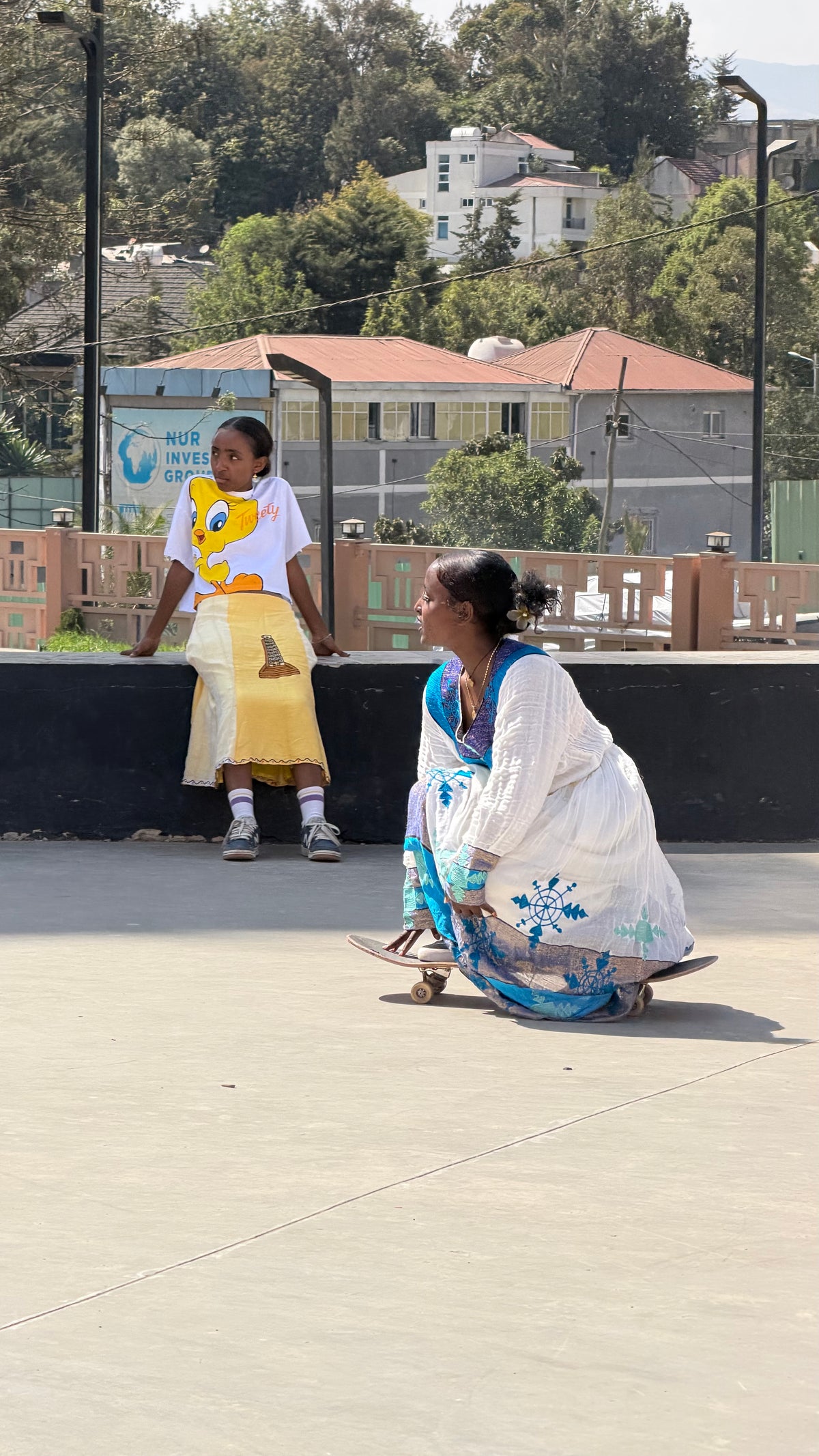 Skateboarding in Addis Ababa, Ethiopia — skating the flat in a traditional dress — photo by Mike Boisvert / The Skate Nomad